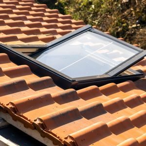 Overlapping rows of yellow ceramic roofing tiles mounted on wood